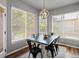 A dining room features a modern chandelier and a table surrounded by six black chairs and backyard views at 3043 W 109Th Pl, Westminster, CO 80031