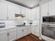 Bright kitchen with marble countertops, stainless steel appliances, white cabinets, and hardwood floors at 3043 W 109Th Pl, Westminster, CO 80031