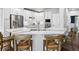 Bright kitchen features white cabinets, stainless steel appliances, and a marble countertop island with seating at 3043 W 109Th Pl, Westminster, CO 80031