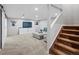 Bright finished basement living room featuring neutral decor, gray couches, and easy access to the carpeted stairs at 3043 W 109Th Pl, Westminster, CO 80031