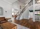 The open-concept living room features a staircase with wooden floors and a view of the dining room and Gathering room at 3043 W 109Th Pl, Westminster, CO 80031