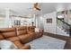 An open-concept living room featuring a staircase, brown sofa, and a view of the kitchen at 3043 W 109Th Pl, Westminster, CO 80031