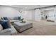 Finished basement living room with neutral decor, sliding barn door and access to bedroom at 3043 W 109Th Pl, Westminster, CO 80031