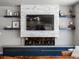 A modern living room featuring a stone accent wall with fireplace and floating shelves at 3043 W 109Th Pl, Westminster, CO 80031