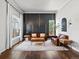 A modern living room featuring hardwood floors, stylish decor, and a dark accent wall at 3043 W 109Th Pl, Westminster, CO 80031