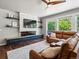 Bright living space with a modern fireplace, stylish shelving, and comfortable leather seating at 3043 W 109Th Pl, Westminster, CO 80031