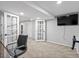 Finished basement office with neutral decor, TV, and access to the gym at 3043 W 109Th Pl, Westminster, CO 80031