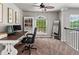 Well-lit office space with large window, ceiling fan, and a bookshelf is great for working from home at 3043 W 109Th Pl, Westminster, CO 80031