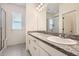 Beautiful bathroom features a double-sink vanity with granite countertop and tiled floors at 4903 Basalt Ridge Cir, Castle Rock, CO 80108