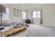 Bright bedroom with neutral carpet features art accents, and large windows with lots of natural light at 4903 Basalt Ridge Cir, Castle Rock, CO 80108
