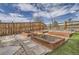 Landscaped backyard with raised garden beds, rock accents, and a privacy fence at 4903 Basalt Ridge Cir, Castle Rock, CO 80108