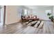 Bright living room with laminate flooring, large windows, and modern furniture at 4903 Basalt Ridge Cir, Castle Rock, CO 80108