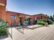 Brick building exterior with bike racks and colorful artwork near entrance at 3304 W 3Rd Ave, Denver, CO 80219