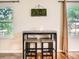 Cozy dining area with bar height table, stools, large window and ample natural light at 3304 W 3Rd Ave, Denver, CO 80219