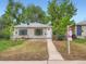 Attractive home with a 'For Sale' sign, nestled among mature trees at 3304 W 3Rd Ave, Denver, CO 80219