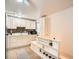 Bright kitchen features white cabinets, stylish backsplash, modern appliances, and functional storage at 3304 W 3Rd Ave, Denver, CO 80219