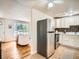Charming kitchen and living room featuring white cabinets, stainless appliances and an open layout at 3304 W 3Rd Ave, Denver, CO 80219