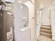 Functional laundry area features stacked washer and dryer, plus a water heater for added convenience at 3304 W 3Rd Ave, Denver, CO 80219