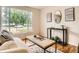 Bright living room featuring hardwood floors and a large window with a pleasant outdoor view at 3304 W 3Rd Ave, Denver, CO 80219