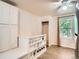 Versatile living space features functional shelving, a closet, large windows and carpeted flooring at 3304 W 3Rd Ave, Denver, CO 80219
