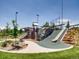 Outdoor play area features a slide, climbing rock structure, and a covered lookout for recreation at 3304 W 3Rd Ave, Denver, CO 80219