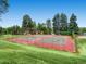 Exterior shot of fenced tennis courts in need of repair at community park and recreational area at 3304 W 3Rd Ave, Denver, CO 80219