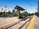 Outdoor train station and platform with ticket machines and station signage at 3304 W 3Rd Ave, Denver, CO 80219