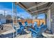 Cozy covered patio area with fire pit and Adirondack chairs for outdoor entertaining at 5295 Perry St, Denver, CO 80212
