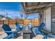 Covered patio features modern fire table surrounded by cozy seating at 5295 Perry St, Denver, CO 80212