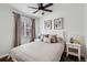 Bedroom with neutral tones, tufted headboard, dark wood floors, and modern art at 5295 Perry St, Denver, CO 80212