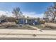 Charming single-story home featuring a gravel yard and easy access to the sidewalk at 5295 Perry St, Denver, CO 80212