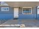 Cozy front porch featuring a 'hello' doormat and classic window design at 5295 Perry St, Denver, CO 80212