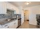 Kitchen with stainless steel appliances and access to a laundry room at 5295 Perry St, Denver, CO 80212