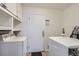 Laundry room with white appliances and shelving at 5295 Perry St, Denver, CO 80212