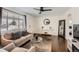 Bright living room with hardwood floors, a ceiling fan and a comfortable seating area at 5295 Perry St, Denver, CO 80212