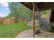 Well-maintained backyard showcasing a lush lawn, landscaping, and a covered patio area at 12466 E Amherst Cir, Aurora, CO 80014