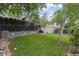 Serene backyard featuring a large lawn, mature trees, and landscaping elements at 12466 E Amherst Cir, Aurora, CO 80014