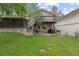 Spacious backyard with a manicured lawn and a two-story deck with stairs and a second story balcony at 12466 E Amherst Cir, Aurora, CO 80014