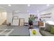 Basement showcasing a painting and art area with a modern sofa, faux grass rug, and open layout at 12466 E Amherst Cir, Aurora, CO 80014