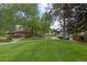 Expansive green space with a walking path leading to community amenities and manicured landscaping at 12466 E Amherst Cir, Aurora, CO 80014