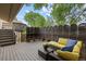 Outdoor deck featuring stylish wicker furniture and privacy screen with potted flowers at 12466 E Amherst Cir, Aurora, CO 80014