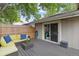 Outdoor wooden deck features a cozy seating area and a sliding glass door to the home's interior at 12466 E Amherst Cir, Aurora, CO 80014