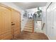 Bright entryway featuring wood floors, stairway, and coat closet at 12466 E Amherst Cir, Aurora, CO 80014