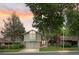 Charming two-story home boasts mature trees, a well-maintained lawn and a two car garage at 12466 E Amherst Cir, Aurora, CO 80014