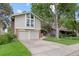 Charming two-story home boasts mature trees, a well-maintained lawn and a two car garage at 12466 E Amherst Cir, Aurora, CO 80014