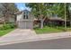 Charming two-story home with a well-kept lawn, mature trees, and an attached two-car garage at 12466 E Amherst Cir, Aurora, CO 80014