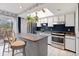 Bright kitchen boasts stainless steel appliances, white cabinets, skylight, and access to outdoor deck at 12466 E Amherst Cir, Aurora, CO 80014