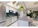 Modern kitchen featuring white cabinets, blue subway tile backsplash, and a bright skylight above at 12466 E Amherst Cir, Aurora, CO 80014