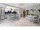 Bright eat-in kitchen with tile floors, stainless appliances, and a stylish breakfast bar for casual dining at 12466 E Amherst Cir, Aurora, CO 80014