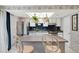 Kitchen with stainless appliances, white cabinets, subway tile backsplash, skylight, and breakfast bar at 12466 E Amherst Cir, Aurora, CO 80014